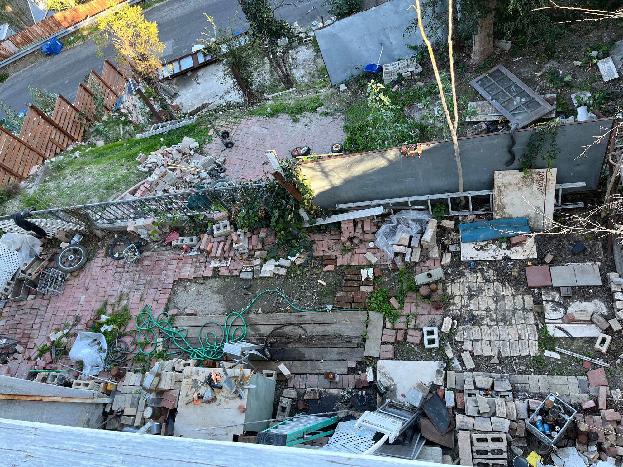 The yard from above before renovation, covered in debris